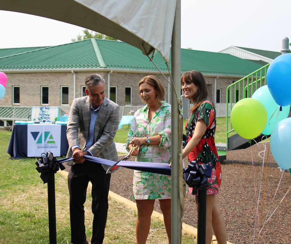 Ethan Long, Leslie Painter, and Abby Donaldson cut a ribbon to celebrate Roanoke VIA Day School's new playground